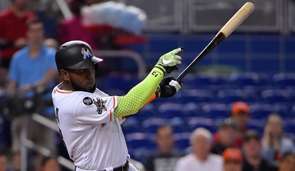 Sep 20, 2017; Miami, FL, USA; Miami Marlins left fielder Marcell Ozuna (13) singles in a run in the first inning against the New York Mets at Marlins Park. Photo Credit: Jasen Vinlove-USA TODAY Sports
