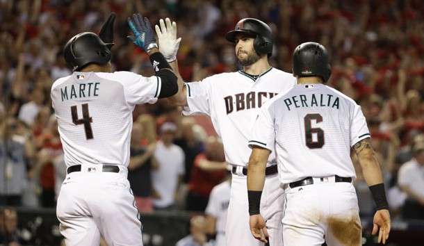 Oct 4, 2017; Phoenix, AZ, USA; Arizona Diamondbacks first baseman Paul Goldschmidt (middle) reacts after hitting a three-run home run to drive in shortstop Ketel Marte (4) and outfielder David Peralta (6) against the Colorado Rockies in the first inning of the 2017 National League wildcard playoff baseball game at Chase Field. Photo Credit: Rob Schumacher/The Arizona Republic via USA TODAY NETWORK