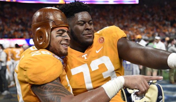 Sep 4, 2017; Atlanta, GA, USA; Tennessee Volunteers linebacker Cortez McDowell (20) wears the old leather helmet as he and offensive lineman Trey Smith (73) react after defeating the Georgia Tech Yellow Jackets at Mercedes-Benz Stadium. Tennessee won 42-41 in two overtimes. Mandatory Credit: Dale Zanine-USA TODAY Sports