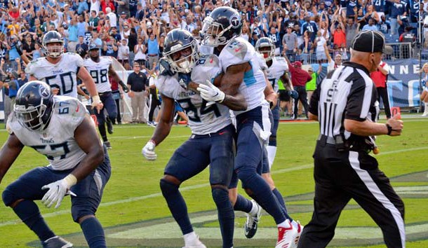 Sep 30, 2018; Nashville, TN, USA; Tennessee Titans wide receiver Corey Davis (84) is congratulated by Tennessee Titans wide receiver Tajae Sharpe (19) after scoring the winning touchdown against the Philadelphia Eagles during overtime at Nissan Stadium. Tennessee won 26-23. Photo Credit: Jim Brown-USA TODAY Sports