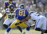 Thomas ends holdout, will report to Seahawks