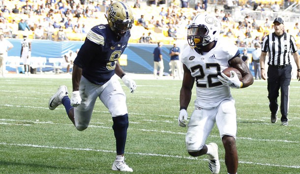 Sep 15, 2018; Pittsburgh, PA, USA;  Georgia Tech Yellow Jackets running back Clinton Lynch (22) scores a touchdown past Pittsburgh Panthers linebacker Saleem Brightwell (9) during the fourth quarter at Heinz Field. Pittsburgh won 24-19. Photo Credit: Charles LeClaire-USA TODAY Sports