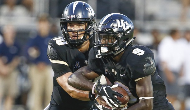 Sep 21, 2018; Orlando, FL, USA; UCF Knights quarterback McKenzie Milton (10) hands off to running back Adrian Killins Jr. (9) during the first quarter against the Florida Atlantic Owls at Spectrum Stadium. Photo Credit: Reinhold Matay-USA TODAY Sports