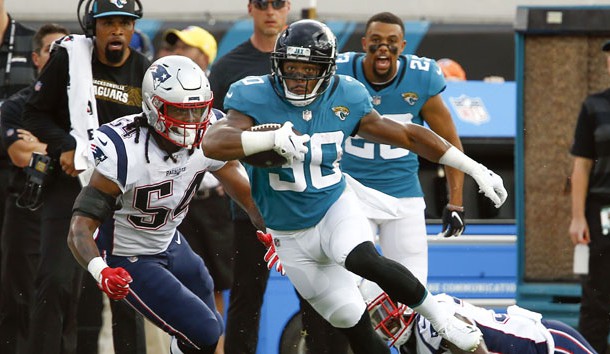 Sep 16, 2018; Jacksonville, FL, USA; Jacksonville Jaguars running back Corey Grant (30) runs between New England Patriots defensive back Jonathan Jones (bottom right) and linebacker Dont'a Hightower (54) during the first quarter at TIAA Bank Field. Photo Credit: Reinhold Matay-USA TODAY Sports