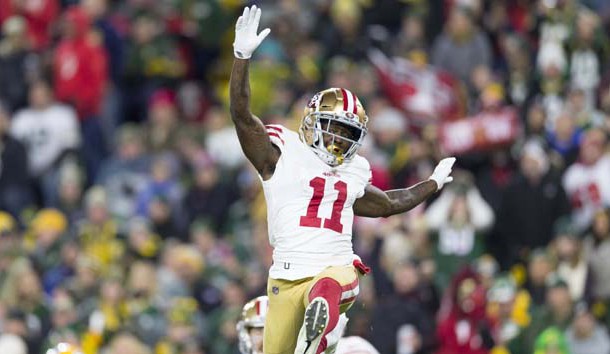 Oct 15, 2018; Green Bay, WI, USA; San Francisco 49ers wide receiver Marquise Goodwin (11) celebrates after scoring a touchdown by performing a long jump during the second quarter against the Green Bay Packers at Lambeau Field. Photo Credit: Jeff Hanisch-USA TODAY Sports