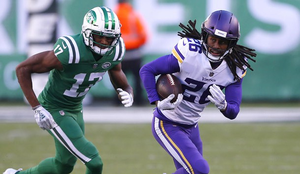 Oct 21, 2018; East Rutherford, NJ, USA; Minnesota Vikings cornerback Trae Waynes (26) runs from New York Jets wide receiver Charone Peake (17) after making an interception during the second half at MetLife Stadium. Photo Credit: Noah K. Murray-USA TODAY Sports