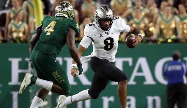 Nov 23, 2018; Tampa, FL, USA;UCF Knights quarterback Darriel Mack Jr. (8) runs with the ball as South Florida Bulls linebacker Greg Reaves (4) pressures during the second half at Raymond James Stadium. Photo Credit: Kim Klement-USA TODAY Sports