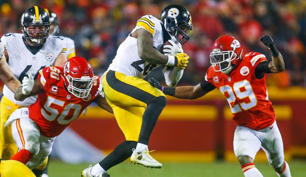 Jan 15, 2017; Kansas City, MO, USA; Pittsburgh Steelers running back Le'Veon Bell (26) is tackled by Kansas City Chiefs linebacker Justin Houston (50) and safety Eric Berry (29) during the first half in the AFC Divisional playoff game at Arrowhead Stadium. The Steelers won 18-16.  Photo Credit: Jay Biggerstaff-USA TODAY Sports