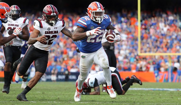 Nov 10, 2018; Gainesville, FL, USA; Florida Gators running back Lamical Perine (22) runs the ball in for a touchdown against South Carolina Gamecocks defensive back Steven Montac (22) during the second half at Ben Hill Griffin Stadium. Photo Credit: Kim Klement-USA TODAY Sports