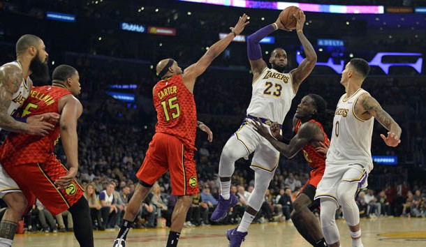 Nov 11, 2018; Los Angeles, CA, USA; Los Angeles Lakers forward LeBron James (23) is guarded by Atlanta Hawks forward Vince Carter (15) and forward Taurean Prince (12) during the second half at Staples Center. Photo Credit: Jake Roth-USA TODAY Sports