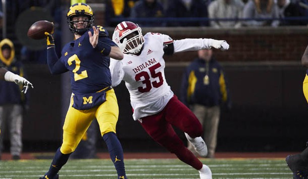Nov 17, 2018; Ann Arbor, MI, USA; Michigan Wolverines quarterback Shea Patterson (2) passes under pressure by Indiana Hoosiers defensive lineman Nile Sykes (35) in the first half at Michigan Stadium. Photo Credit: Rick Osentoski-USA TODAY Sports