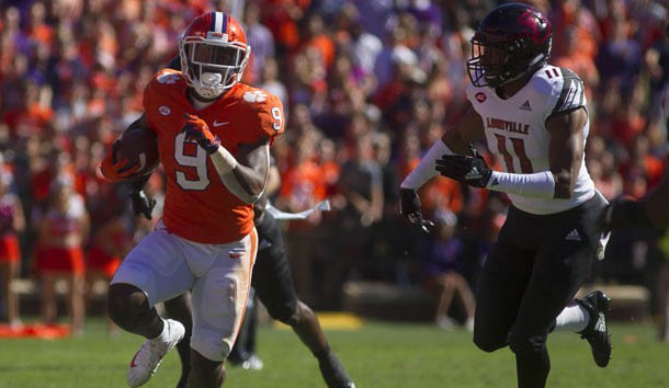 Nov 3, 2018; Clemson, SC, USA; Clemson Tigers running back Travis Etienne (9) avoids a tackle from Louisville Cardinals safety Dee Smith (11) during the first half at Clemson Memorial Stadium. Photo Credit: Joshua S. Kelly-USA TODAY Sports