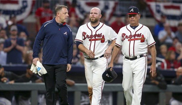 Apr 6, 2019; Atlanta, GA, USA; Atlanta Braves catcher Brian McCann (middle) leaves the field with trainer Mike Frostad (left) and manager Brian Snitker (right) after suffering an apparent injury against the Miami Marlins in the fourth inning at SunTrust Park. Photo Credit: Brett Davis-USA TODAY Sports