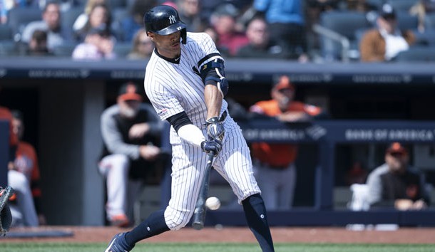 Mar 30, 2019; Bronx, NY, USA; New York Yankees left fielder Giancarlo Stanton (27) hits a single against the Baltimore Orioles during the third inning at Yankee Stadium. Photo Credit: Gregory J. Fisher-USA TODAY Sports