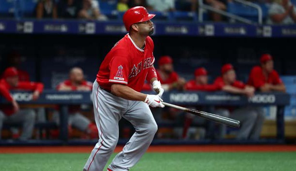 Jun 14, 2019; St. Petersburg, FL, USA; Los Angeles Angels first baseman Albert Pujols (5) hits a sacrifice RBI during the first inning against the Tampa Bay Rays at Tropicana Field. Photo Credit: Kim Klement-USA TODAY Sports