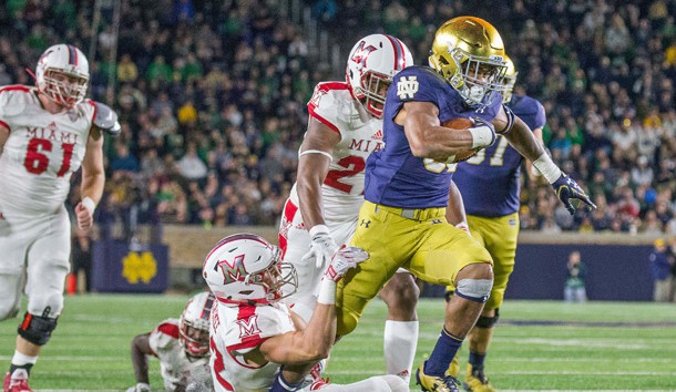 Sep 30, 2017; South Bend, IN, USA; Notre Dame Fighting Irish running back Deon McIntosh (38) runs out of the tackle of Miami (Oh) Redhawks defensive back Matt Merimee (22) in the second half of the game at Notre Dame Stadium. Photo Credit: Trevor Ruszkowski-USA TODAY Sports