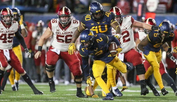 Nov 23, 2018; Morgantown, WV, USA; West Virginia Mountaineers safety Kenny Robinson Jr. (2) recovers a fumble during the second quarter against the Oklahoma Sooners at Mountaineer Field at Milan Puskar Stadium. Photo Credit: Ben Queen-USA TODAY Sports