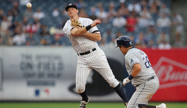 Jul 18, 2019; Bronx, NY, USA; New York Yankees second baseman DJ LeMahieu (26) forces out Tampa Bay Rays first baseman Ji-Man Choi (26) and throws to first base on a ball hit by Tampa Bay Rays catcher Travis d'Arnaud (not pictured) during the seventh inning of the first game of a doubleheader at Yankee Stadium. The throw by LeMahieu was not in time to complete a double play. Photo Credit: Brad Penner-USA TODAY Sports