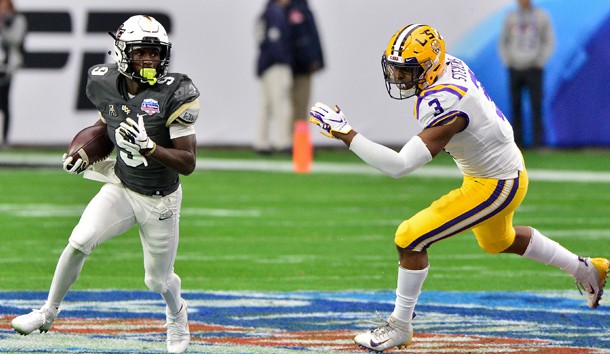 Jan 1, 2019; Glendale, AZ, USA; UCF Knights running back Adrian Killins Jr. (9) runs the ball as LSU Tigers safety JaCoby Stevens (3) chases during the first half during the 2019 Fiesta Bowl at State Farm Stadium. Photo Credit: Matt Kartozian-USA TODAY Sports