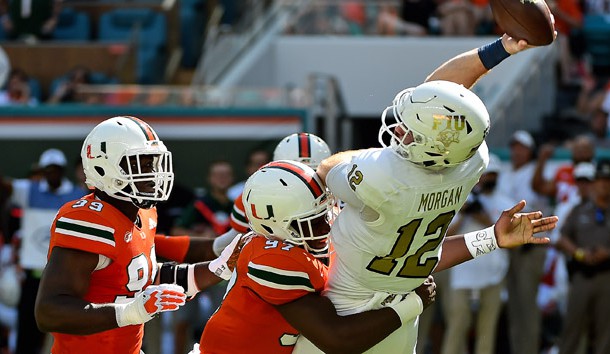 Sep 22, 2018; Miami Gardens, FL, USA; Miami Hurricanes defensive lineman Jonathan Garvin (97) pressures FIU Golden Panthers quarterback James Morgan (12) during the first half at Hard Rock Stadium. Photo Credit: Jasen Vinlove-USA TODAY Sports