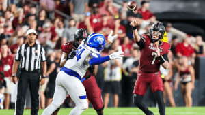 South Carolina QB Spencer Rattler throws a pass, while his lineman blocks a Georgia State defender.